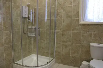 a shower stall in a bathroom with a toilet at Mardonia Hotel in Blackpool