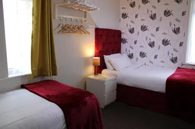 a hotel room with two beds and a window at Mardonia Hotel in Blackpool