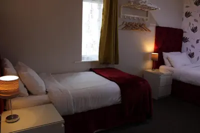 a small bedroom with a bed and a window at Mardonia Hotel in Blackpool