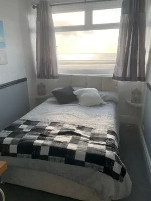 a bedroom with a bed with pillows and a window at St Albans Hotel in Blackpool