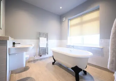 a white bathroom with a tub and a sink at Miller & Carter Aughton by Innkeeper's Collection in Ormskirk