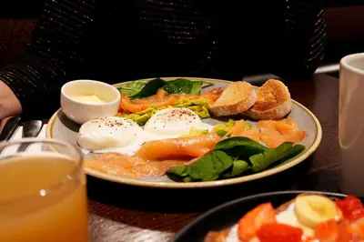a plate of food with eggs and vegetables on a table at Miller & Carter Aughton by Innkeeper's Collection in Ormskirk