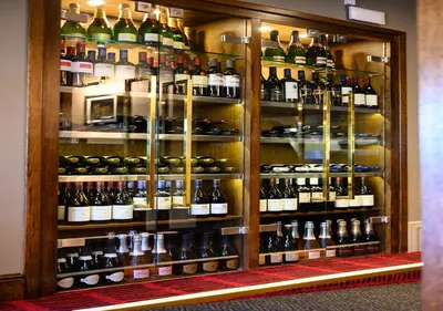 a display case filled with lots of bottles of wine at Miller & Carter Aughton by Innkeeper's Collection in Ormskirk