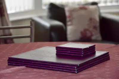 a stack of books sitting on top of a table at Empress Select Holiday Flats in Blackpool