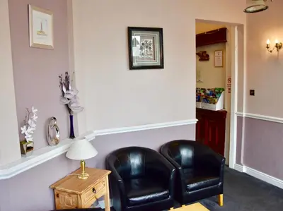 two black leather chairs sitting in a living room at Empress Select Holiday Flats in Blackpool