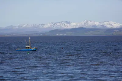 a blue boat in the middle of a large body of water at Best Western Lancaster Morecambe Lothersdale Hotel in Morecambe