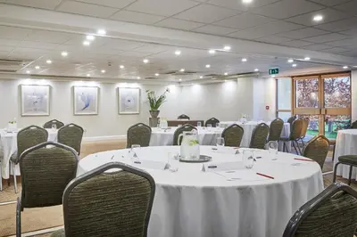 a conference room with tables and chairs with white table cloth at Wrightington Hotel, Health Club & Spa in Wigan