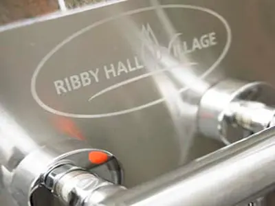 a close up of a shiny metal object with the words rusty hallnance at The Motel, Ribby Hall Village in Wrea Green