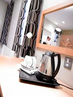 a tea kettle sitting on a counter in front of a mirror at The Motel, Ribby Hall Village in Wrea Green