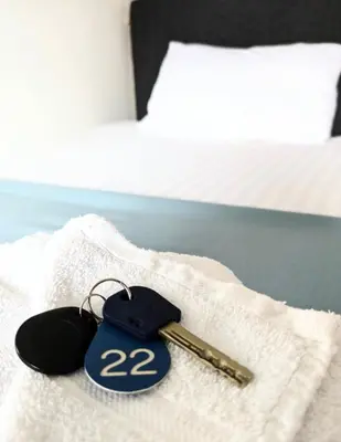 a pair of keys sitting on a bed at West Point House in Barrow in Furness