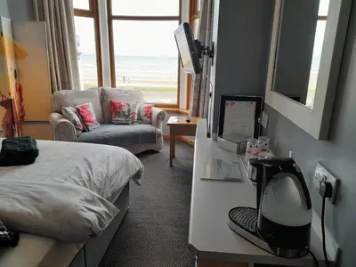 a hotel room with a bed and a desk with a computer at The Fame in Blackpool