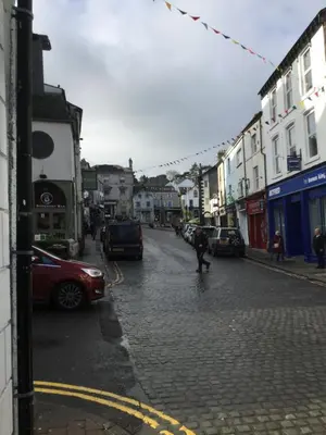 a person riding a skateboard down a city street at 2 leather lane in Ulverston