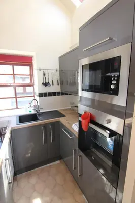 a kitchen with a microwave oven and a sink at 2 leather lane in Ulverston