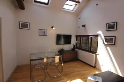 a living room with a table and chairs in a room at 2 leather lane in Ulverston