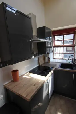 a kitchen with a stove and a counter top at 2 leather lane in Ulverston