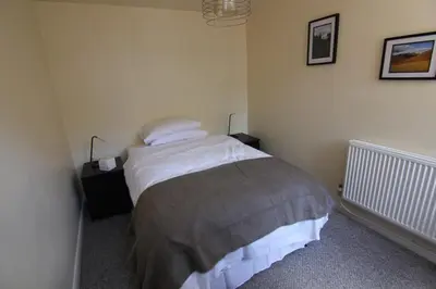 a bedroom with a bed with two pillows on it at 2 leather lane in Ulverston