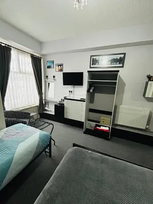 a hotel room with a bed and a tv and a bedroom at Hornby Villa B&B Couples & Families Only- Quiet Central Location- Near To Winter Gardens in Blackpool