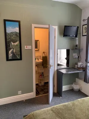 a room with a bedroom with a desk and a mirror at Hornby Villa B&B Couples & Families Only- Quiet Central Location- Near To Winter Gardens in Blackpool