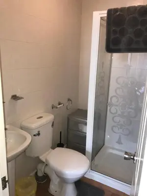 a bathroom with a toilet and a sink and a shower at Beach View Holiday Flats in Blackpool