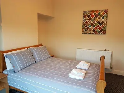 a bedroom with a bed with two towels on it at Central Location Preston 2 in Preston