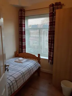 a small bedroom with a bed and a window at Central Location Preston 2 in Preston