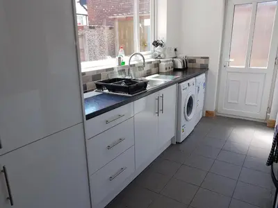 a kitchen with a sink and a washing machine at Central Location Preston 2 in Preston