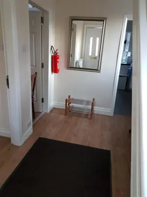 a hallway with a bench and a mirror on the wall at Central Location Preston 2 in Preston