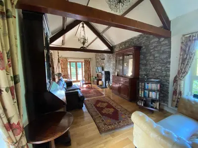 a living room with a couch and a table at The Stables, Ulverston in Ulverston