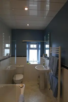 a bathroom with a toilet and a tub and a sink at Kentwood Guest House in Arnside