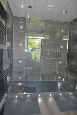a bathroom with a shower with a glass wall at Kentwood Guest House in Arnside