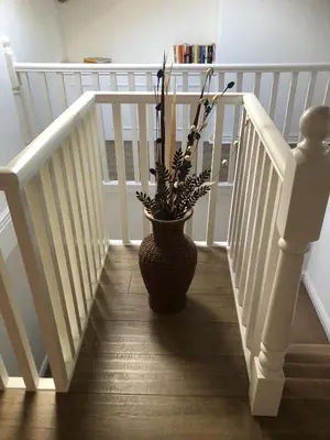 a vase with a plant sitting on the stairs at Beach House - Penthouse 3 Bed Apartment in Southport