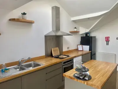 a kitchen with a sink and a counter top at Beach House - Penthouse 3 Bed Apartment in Southport