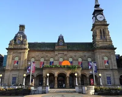 a large building with a clock tower on top of it at Beach House - Penthouse 3 Bed Apartment in Southport