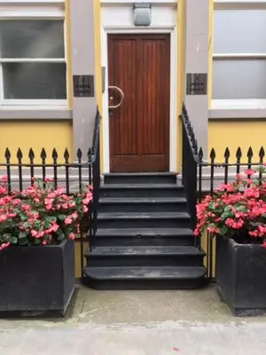 a front door of a house with stairs and flowers at The Castle Collection - 3 Union Court in Liverpool
