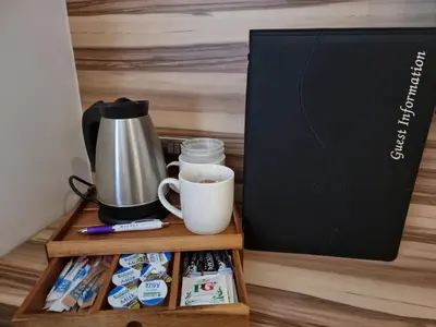 a wooden shelf with a coffee maker and a cup of coffee at Escape Hotel in Barrow in Furness