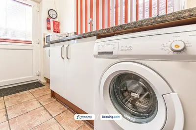 a white washer and dryer in a laundry room at Wigan Work-Ready 3BR House Sleeps 6 Guests in Wigan