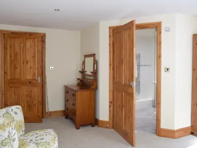 a room with a door and a chair and a mirror at The Old Dairy - Ukc3413 in Bolton by Bowland