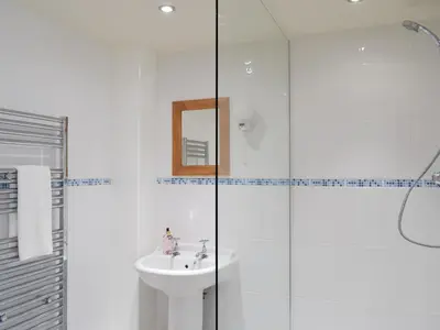 a bathroom with a sink and a glass shower at The Old Dairy - Ukc3413 in Bolton by Bowland