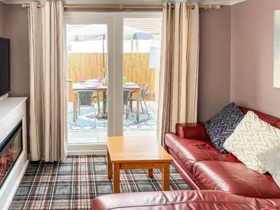 a living room with a couch and a table at Jasmin's Retreat in Cleveleys
