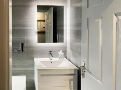 a bathroom with a white sink and a mirror at Jasmin's Retreat in Cleveleys
