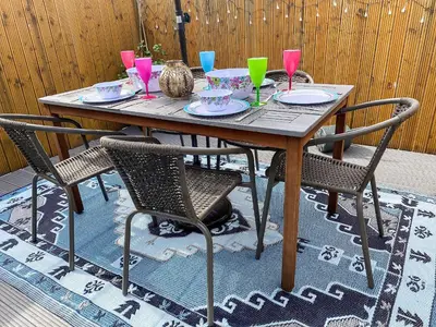 a wooden table with chairs and drinks on it at Jasmin's Retreat in Cleveleys