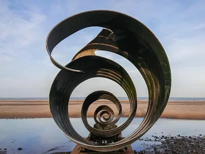 a metal sculpture on the shore of a beach at Jasmin's Retreat in Cleveleys