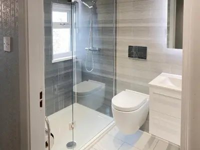 a bathroom with a shower and a toilet and a sink at Jasmin's Retreat in Cleveleys