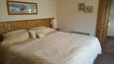 a bedroom with a large white bed with pillows at The Coach House Holiday Cottage, Southport in Southport
