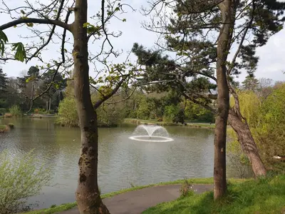 a fountain in the middle of a pond at The Coach House Holiday Cottage, Southport in Southport