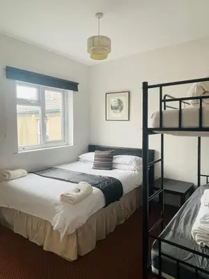 a bedroom with two bunk beds and a window at Sea Princess Hotel Blackpool in Blackpool