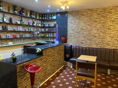 a bar in a restaurant with a bench and a table at Sea Princess Hotel Blackpool in Blackpool