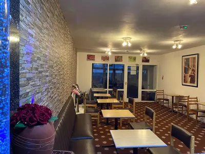 a restaurant with tables and chairs and a brick wall at Sea Princess Hotel Blackpool in Blackpool