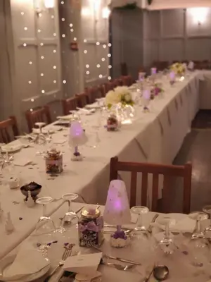 a long table with white table cloths and flowers on it at The Melville Hotel - Central Location in Blackpool