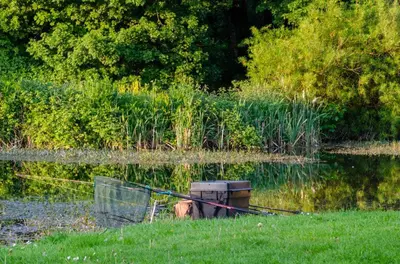 a boat sitting in the middle of a body of water at Carmels Caravan Borwick Lakes in Carnforth